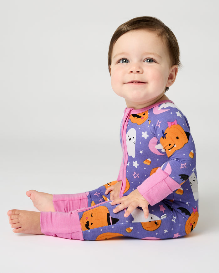Sitting baby wearing the Moonlit Magic Purple Zippy