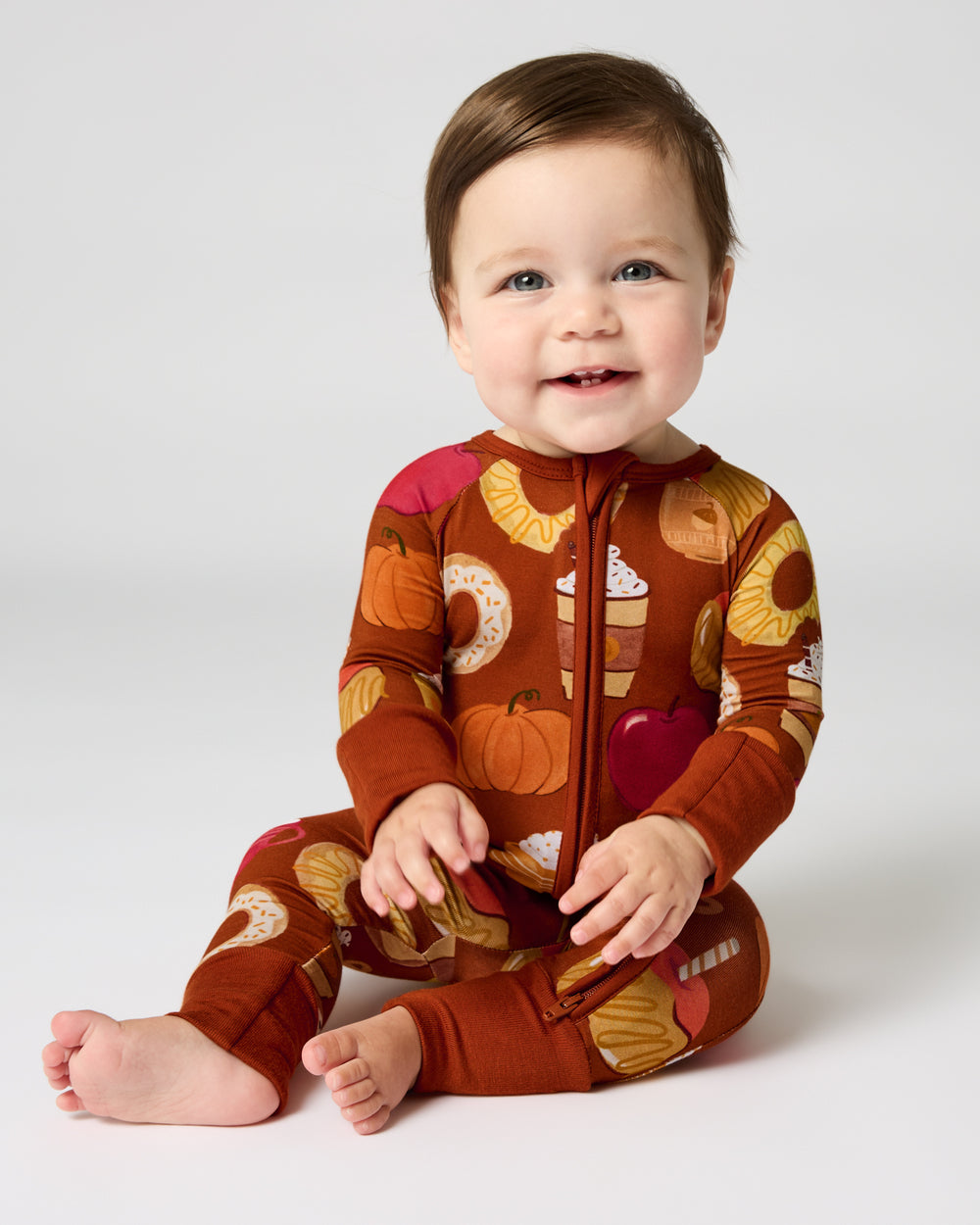 Sitting baby wearing the Harvest Sweets Zippy