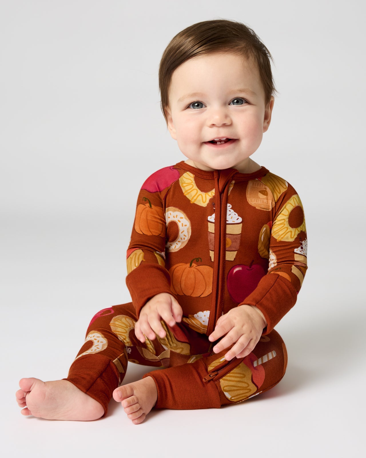 Sitting baby wearing the Harvest Sweets Zippy