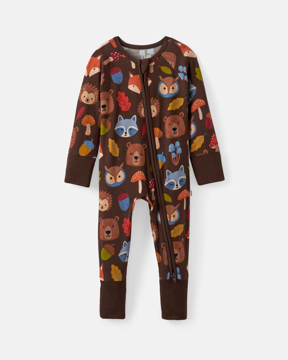 A baby's long-sleeve zip-up footed sleeper in dark brown, featuring an all-over woodland print of bears, foxes, raccoons, hedgehogs, acorns, and autumn leaves.