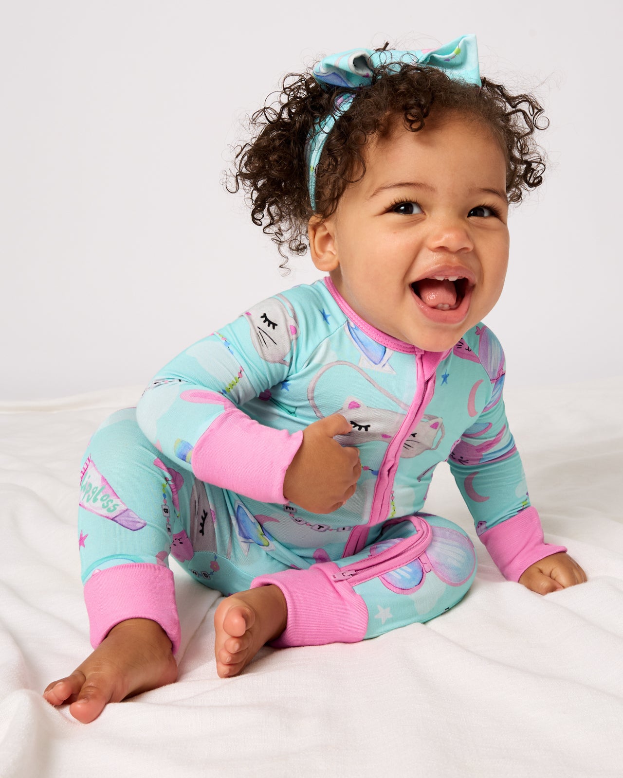 Baby wearing the Slumber Club Zippy and Bow