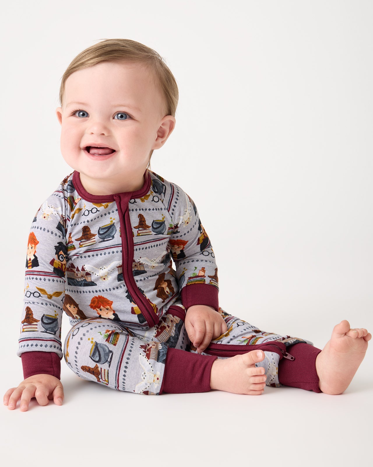 Sitting baby wearing the Harry Potter™ Spellbinding Studies Zippy