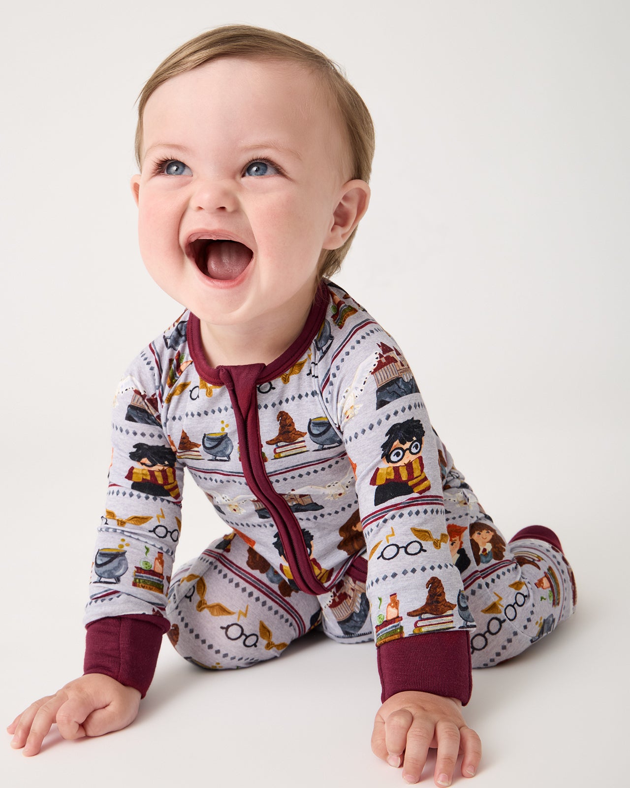 Crawling baby wearing the Harry Potter™ Spellbinding Studies Zippy
