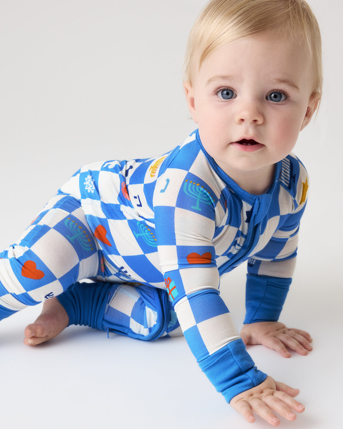 Crawling baby wearing the Hanukkah Checks Zippy