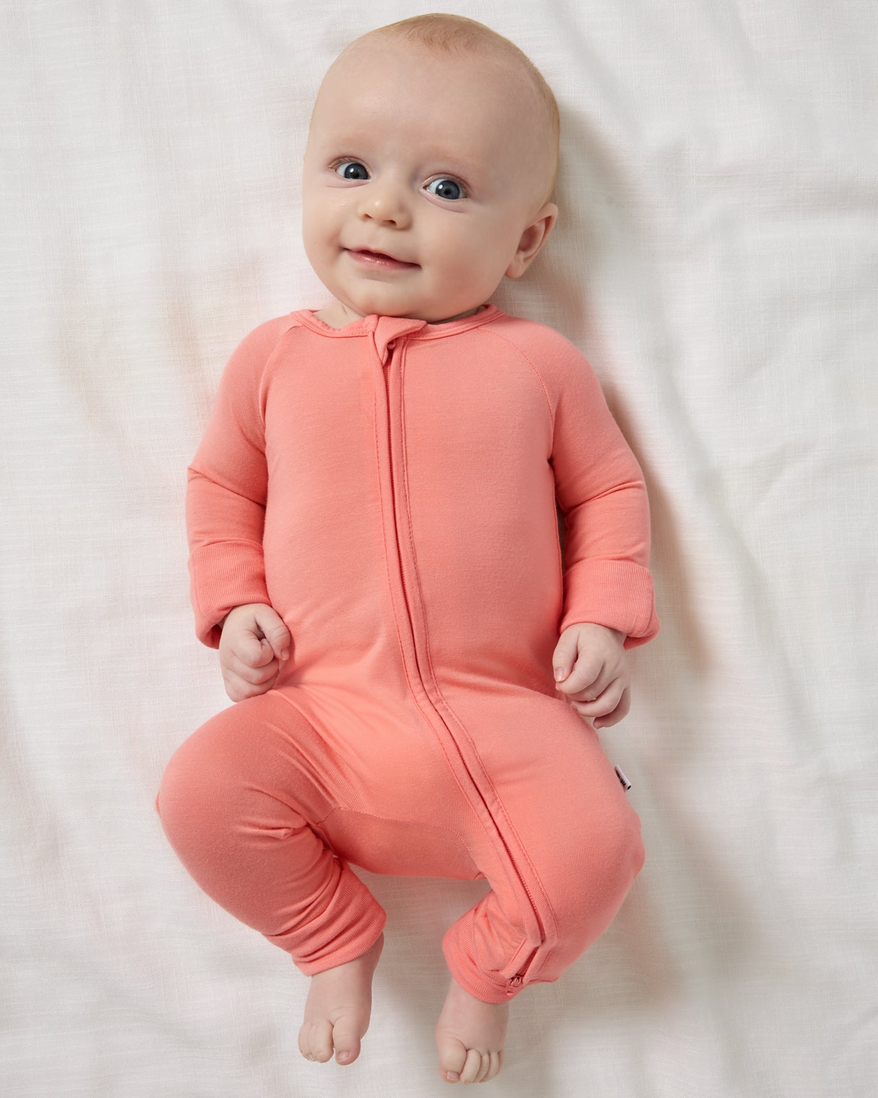 Aerial view of newborn wearing the Sweet Papaya Zippy
