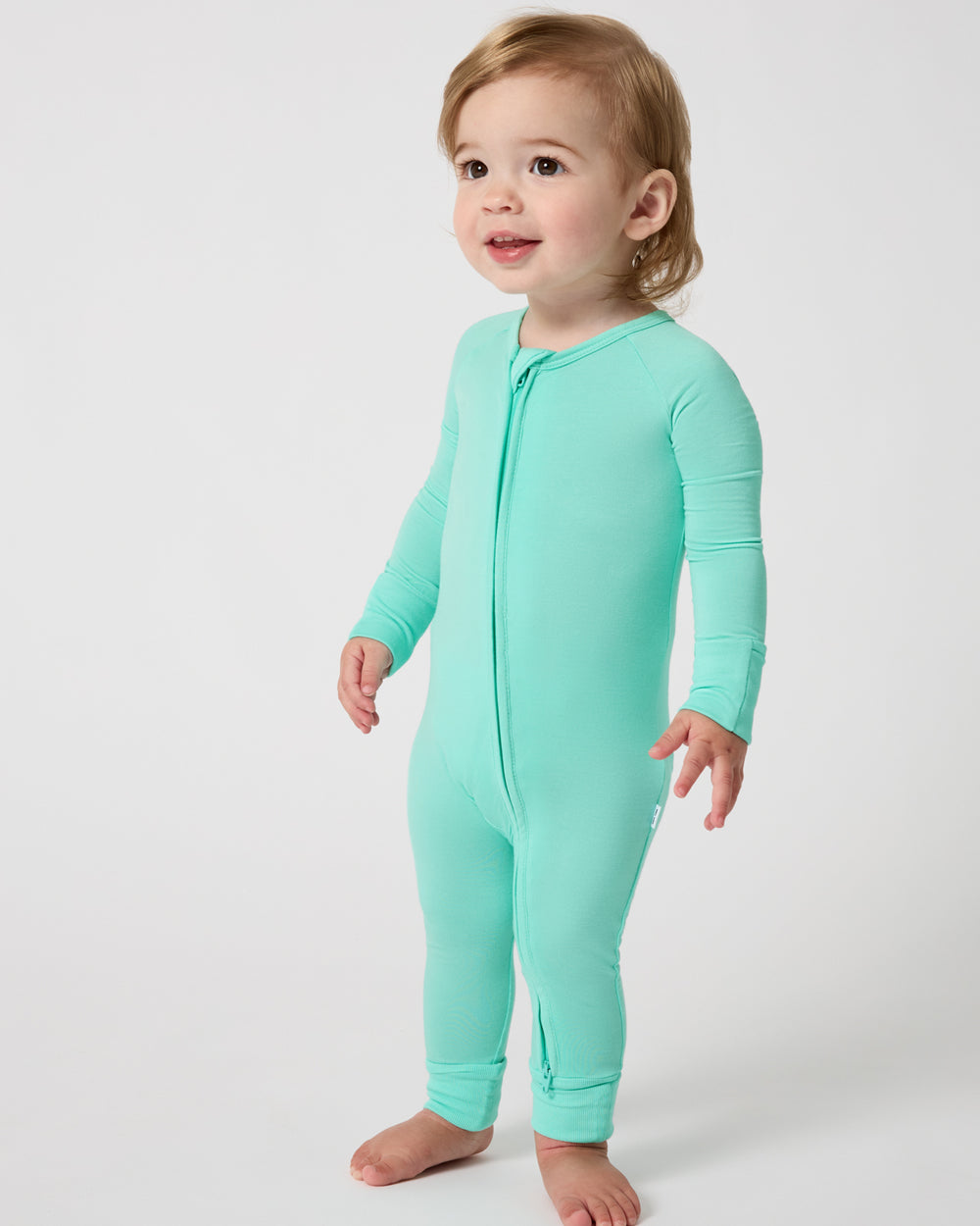 Standing baby wearing the Ocean Mist Zippy