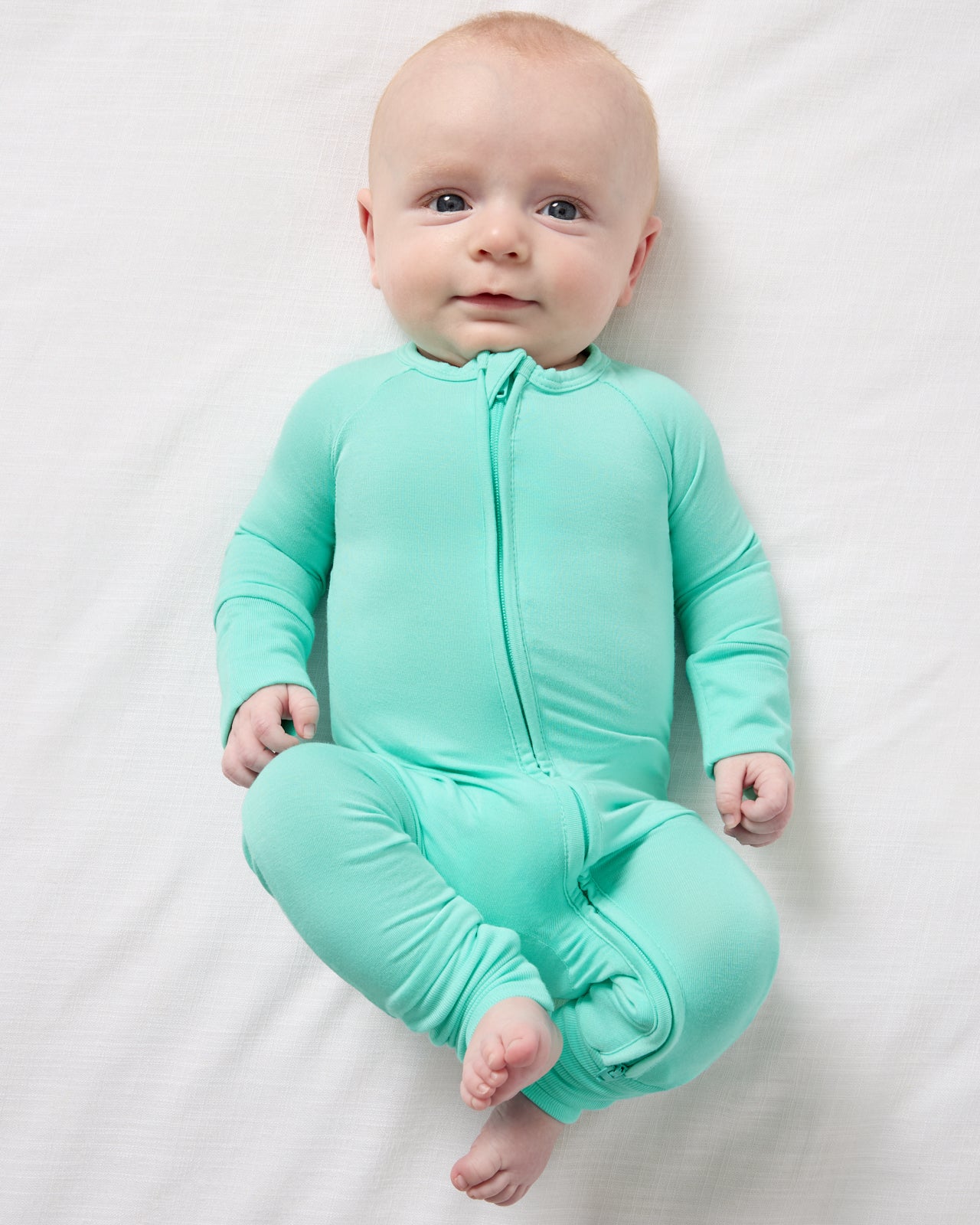 Aerial view of newborn wearing the Ocean Mist Zippy 