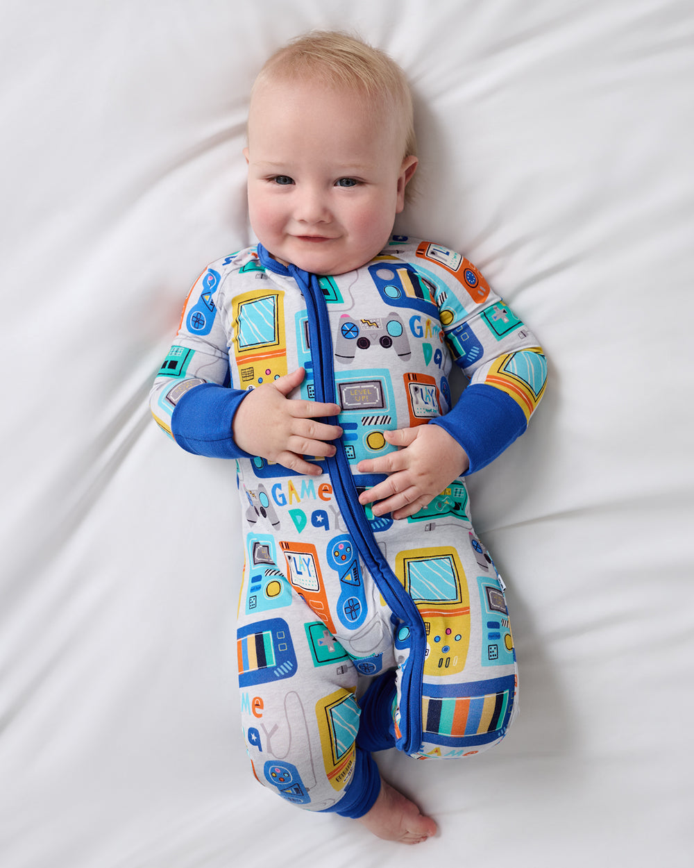 Aerial view of newborn wearing the Game On Zipper Pajama
