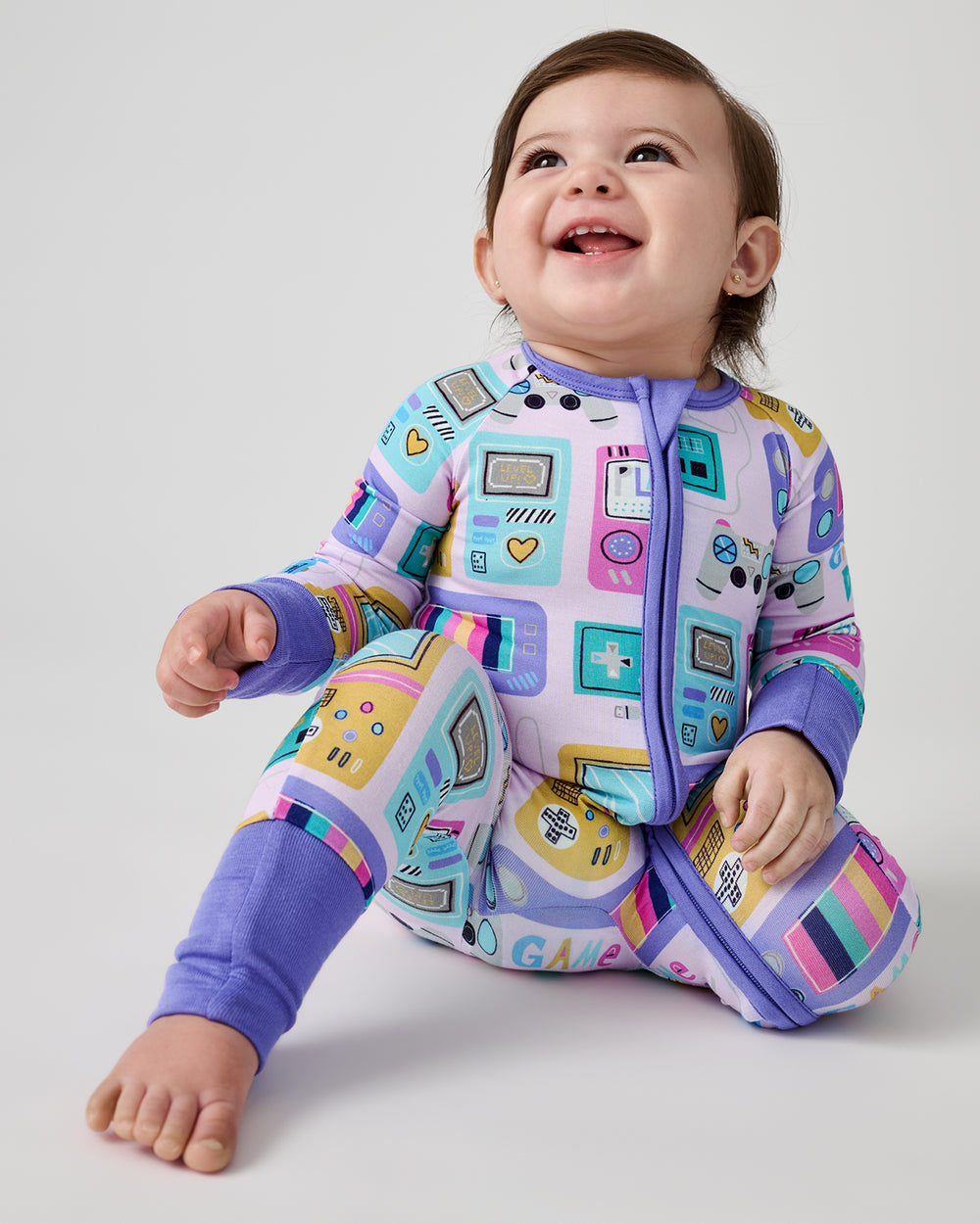 Alternate of sitting newborn wearing the Purple Game On Zippy