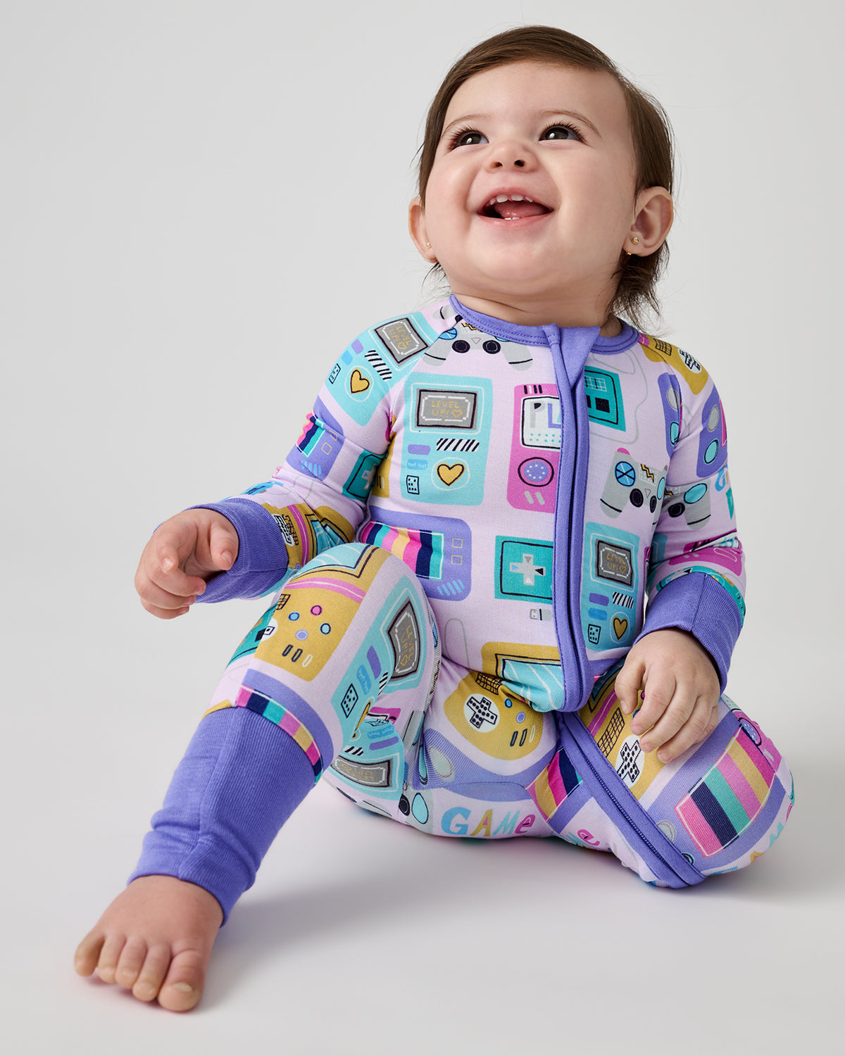 Alternate of sitting newborn wearing the Purple Game On Zippy