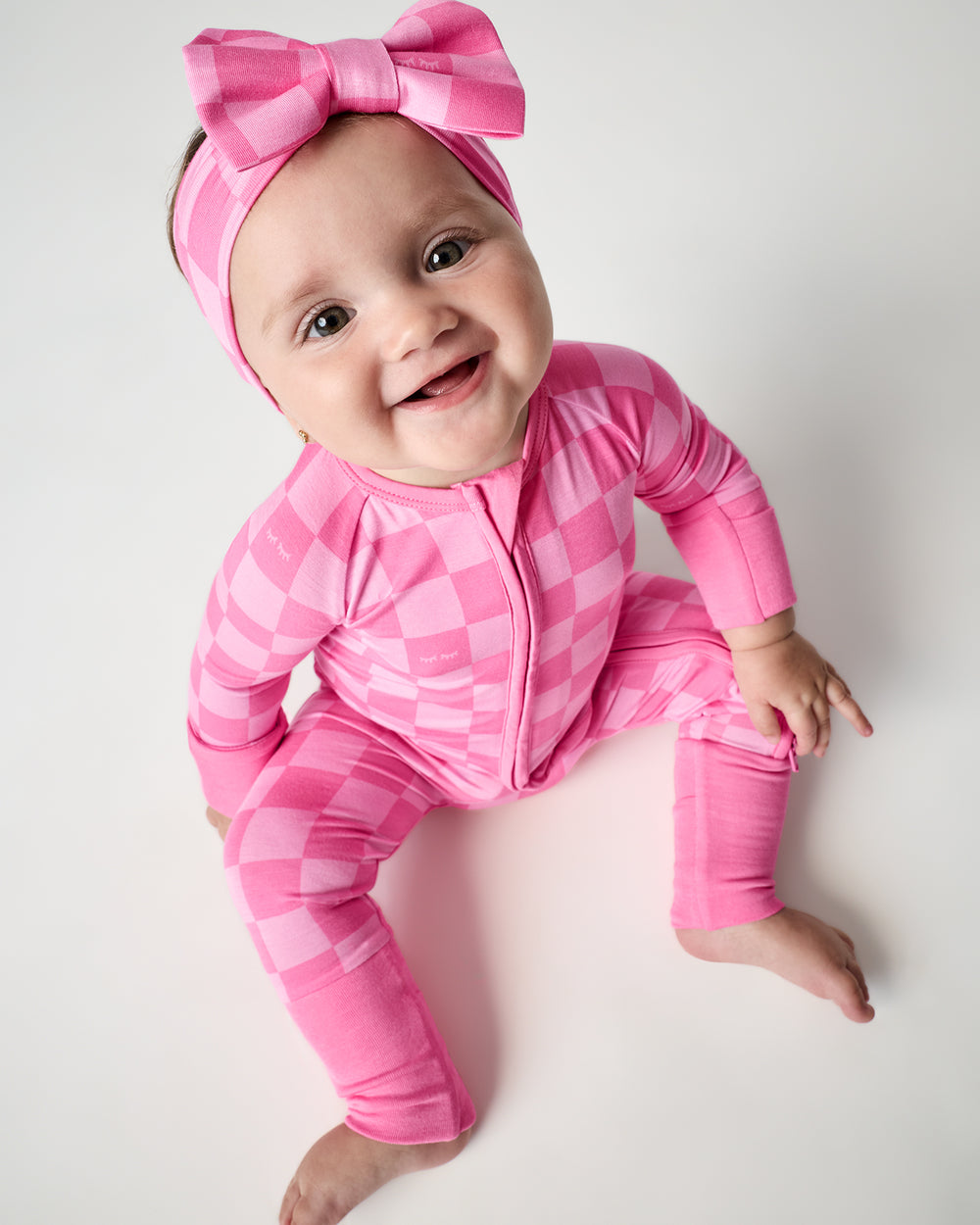 Sitting baby wearing the Sweet Raspberry Checks Luxe Bow Headband with a matching bow