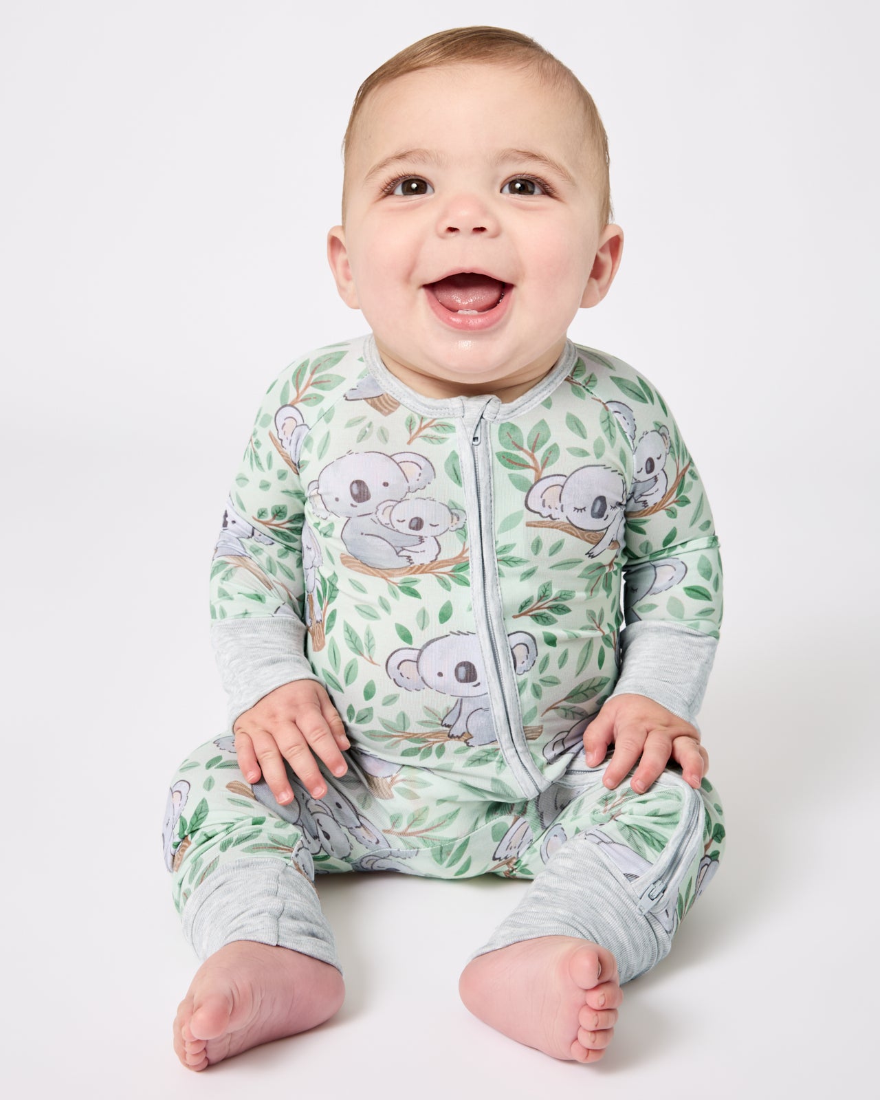 Sitting baby wearing the Koala Cuddles Zippy