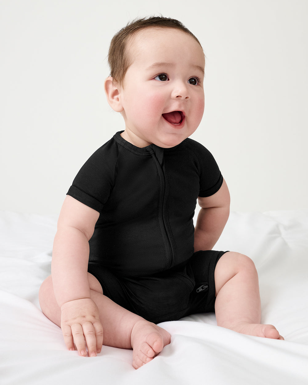 Sitting baby wearing the Black Shorty Zippy
