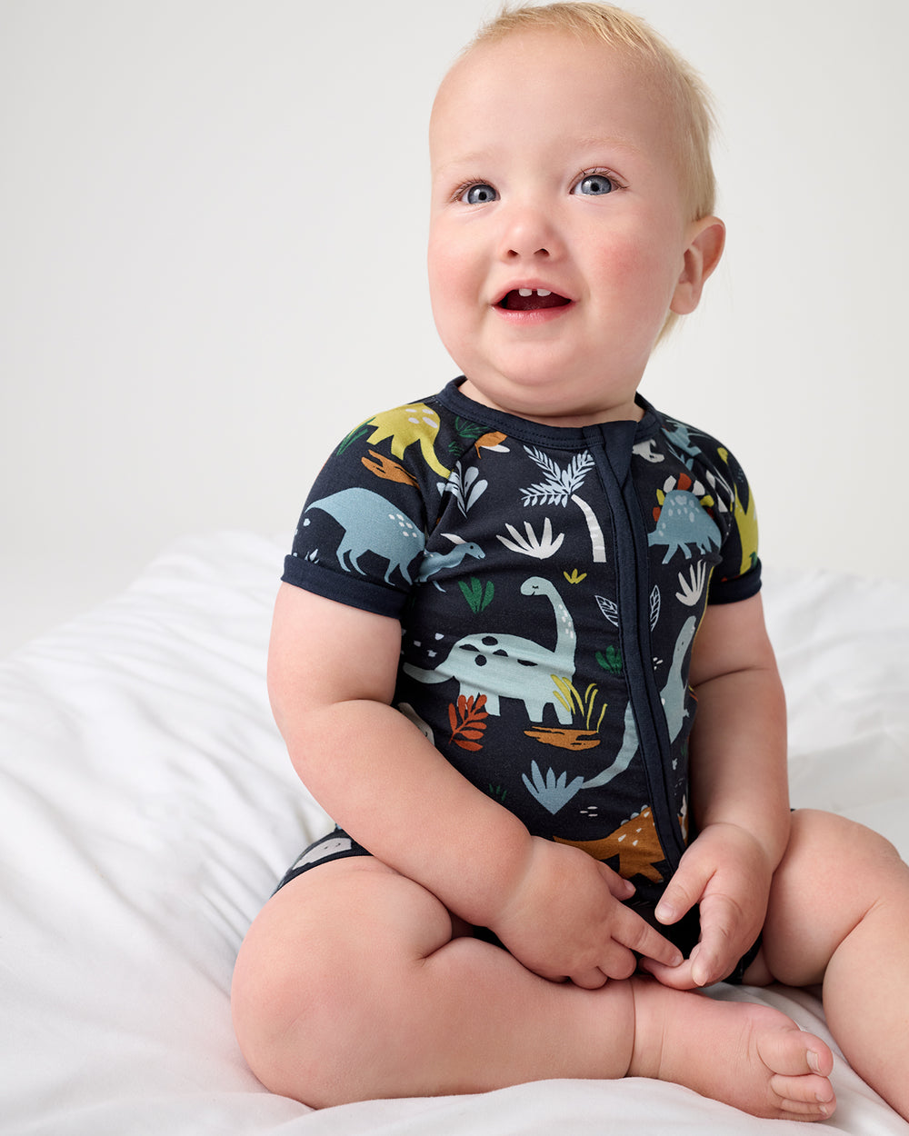 Baby boy wearing the Navy Jurassic Jungle Shorty Zippy