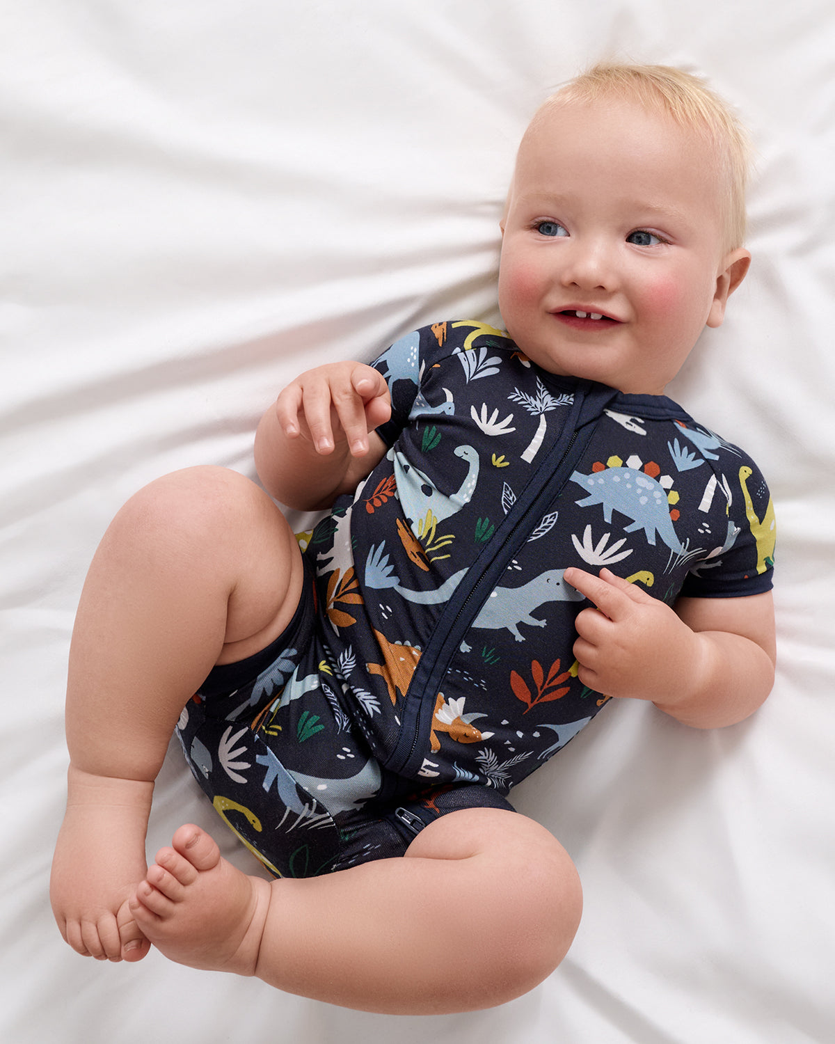 Aerial view of baby wearing the Navy Jurassic Jungle Shorty Zippy