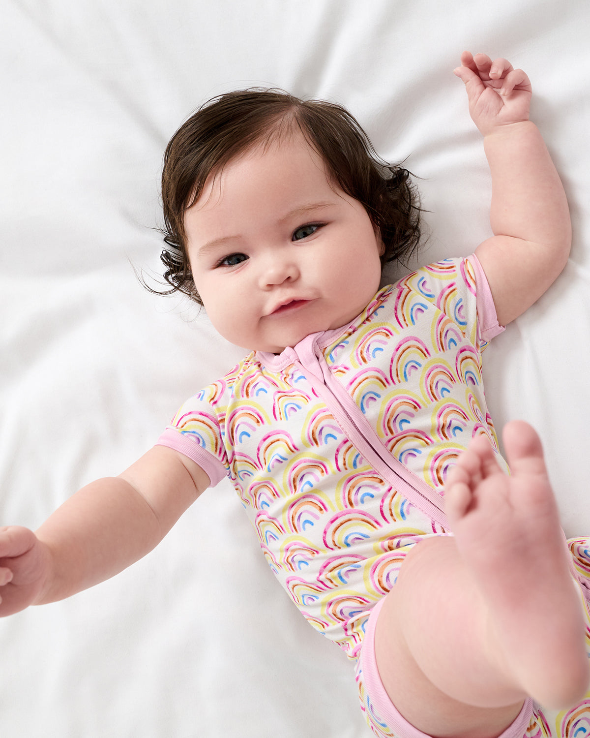 Child in motion wearing the Pastel Rainbows Shorty Zippy