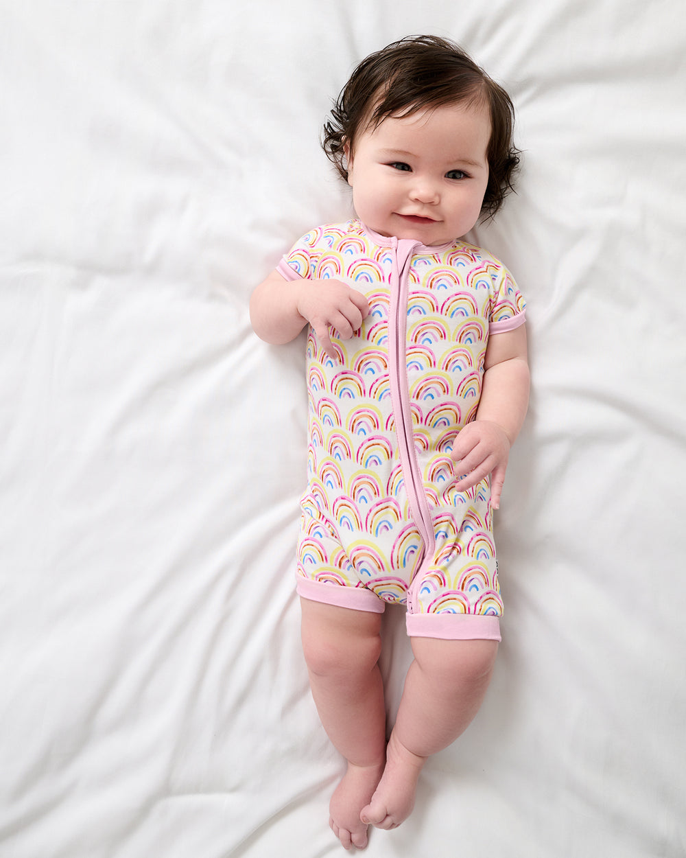 Aerial view of baby wearing the Pastel Rainbows Shorty Zippy