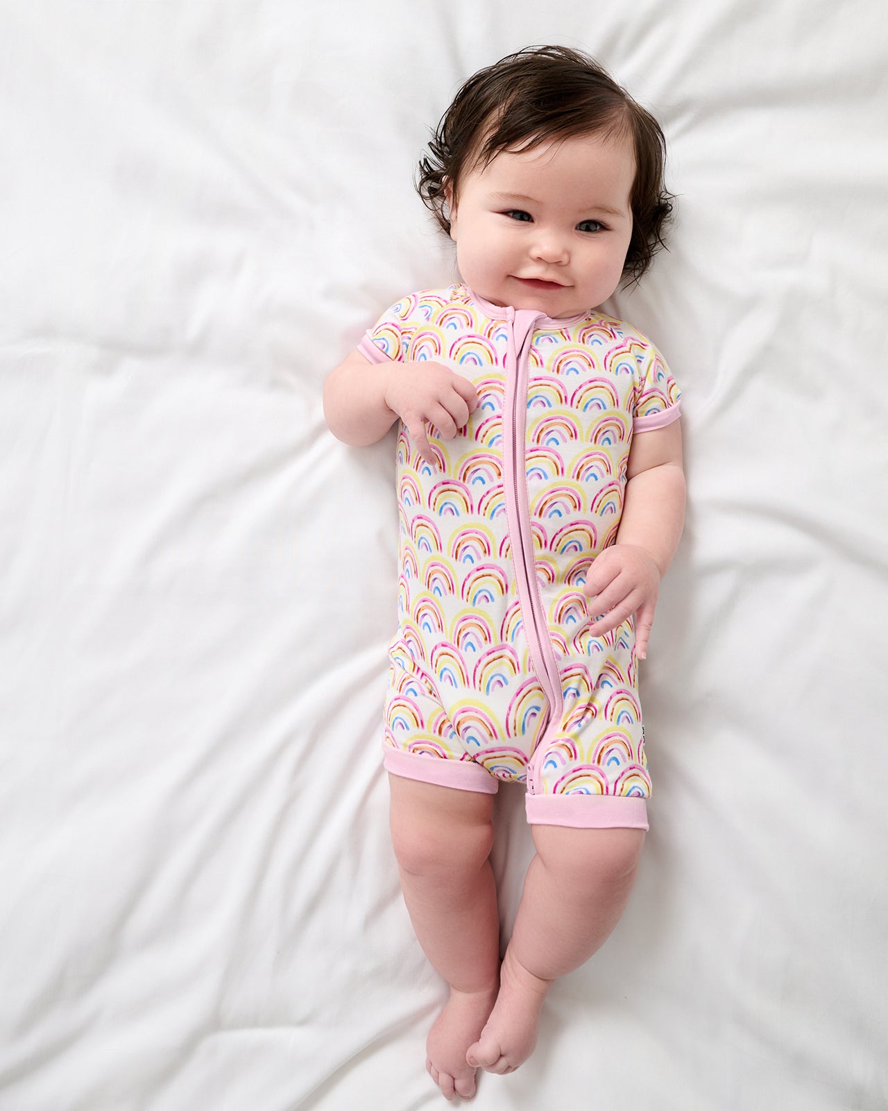 Aerial view of baby wearing the Pastel Rainbows Shorty Zippy