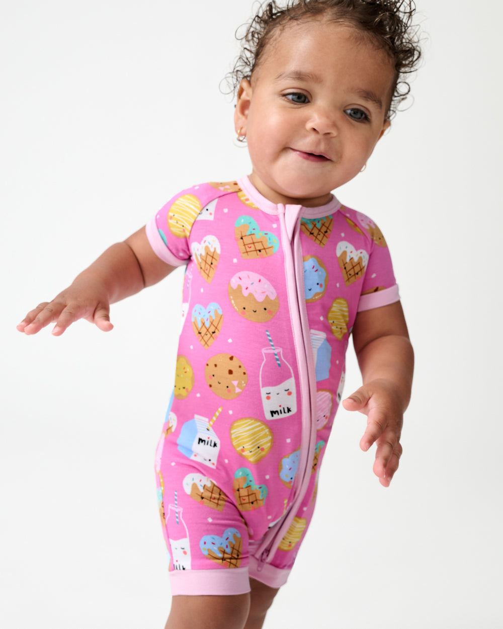 Walking toddler wearing the Pink Cookies & Milk Shorty Zippy