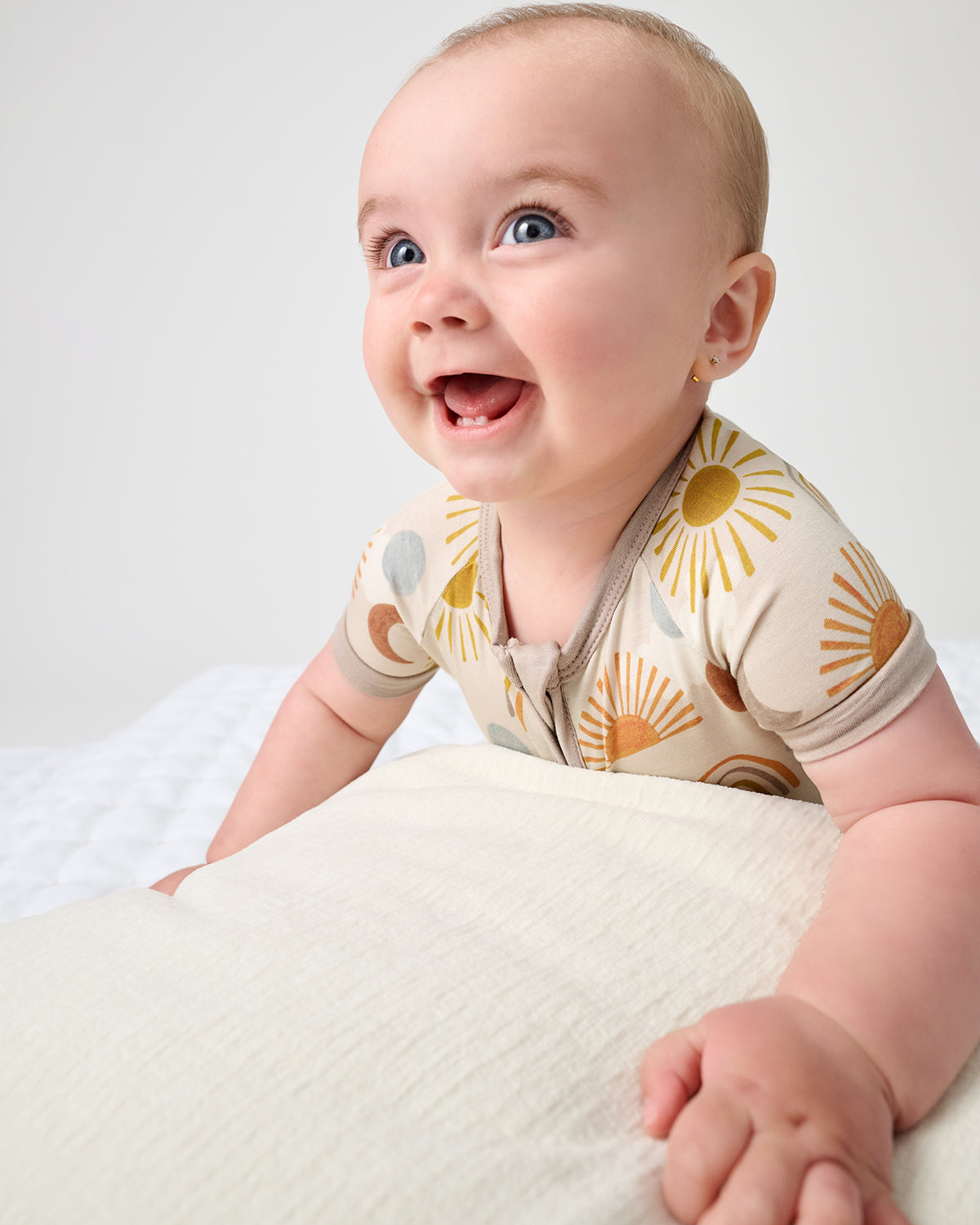 Smiling baby wearing the Desert Sunrise Shorty Zipper Pajama
