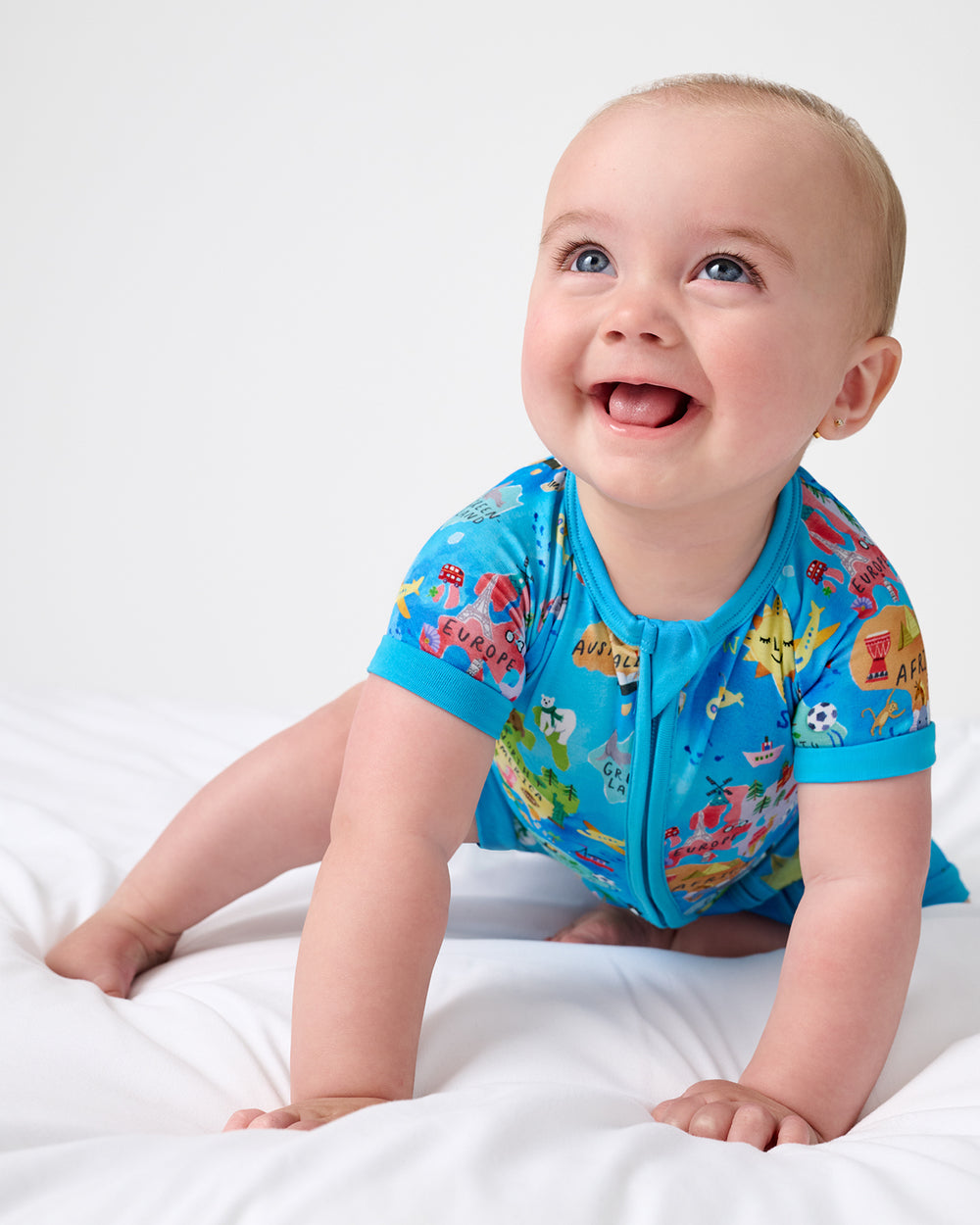 Crawling baby wearing the Around The World Shorty Zippy