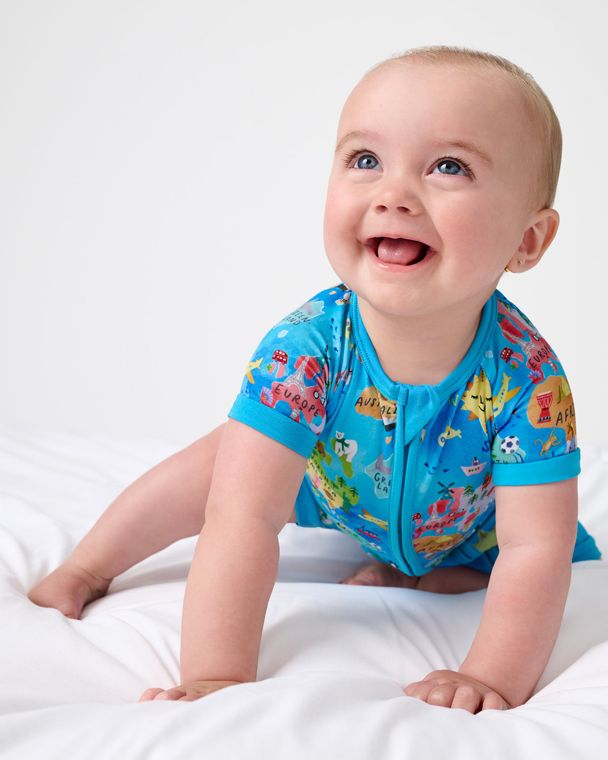 Crawling baby wearing the Around The World Shorty Zippy