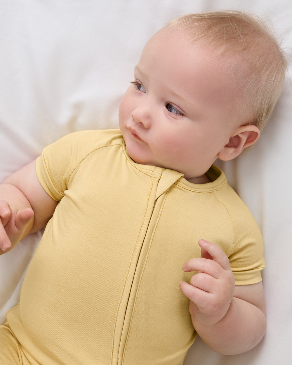 Close up aerial view of baby wearing the Sunglow Shorty Zippy