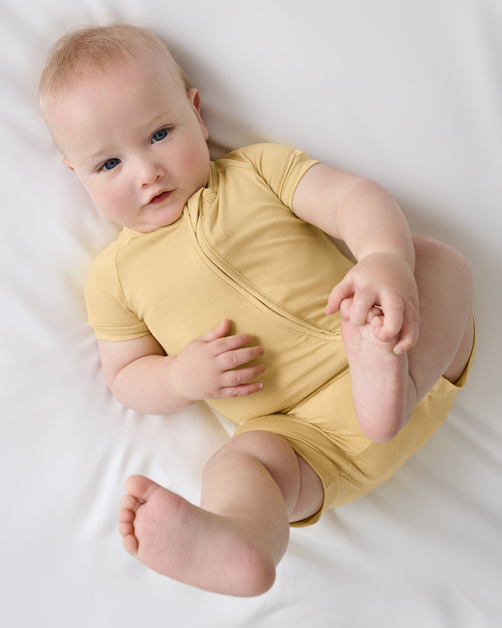 Aerial view of baby wearing the Sunglow Shorty Zippy