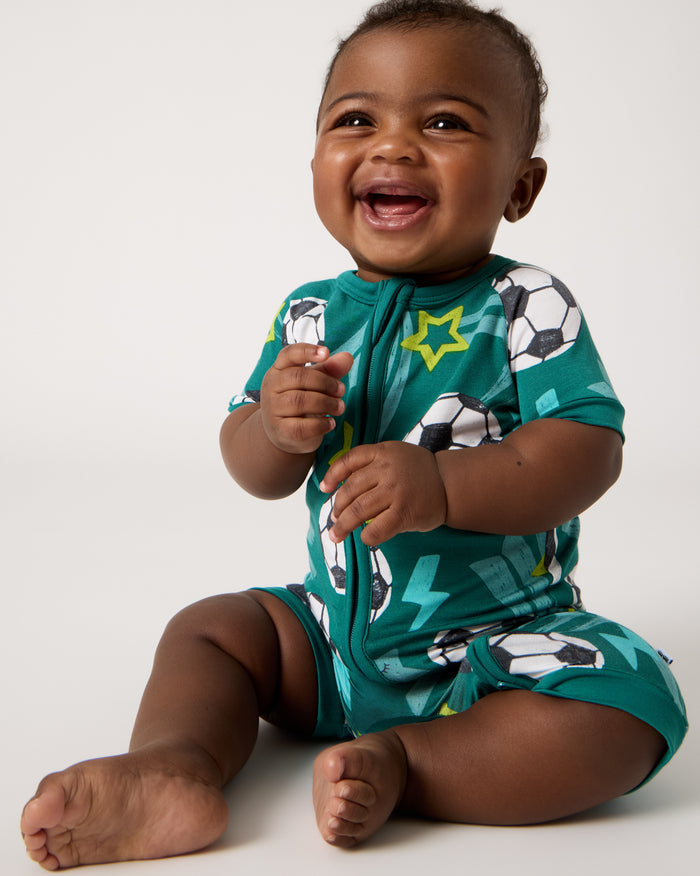 Front view of sitting baby wearing the Soccer Stars Shorty Zippy