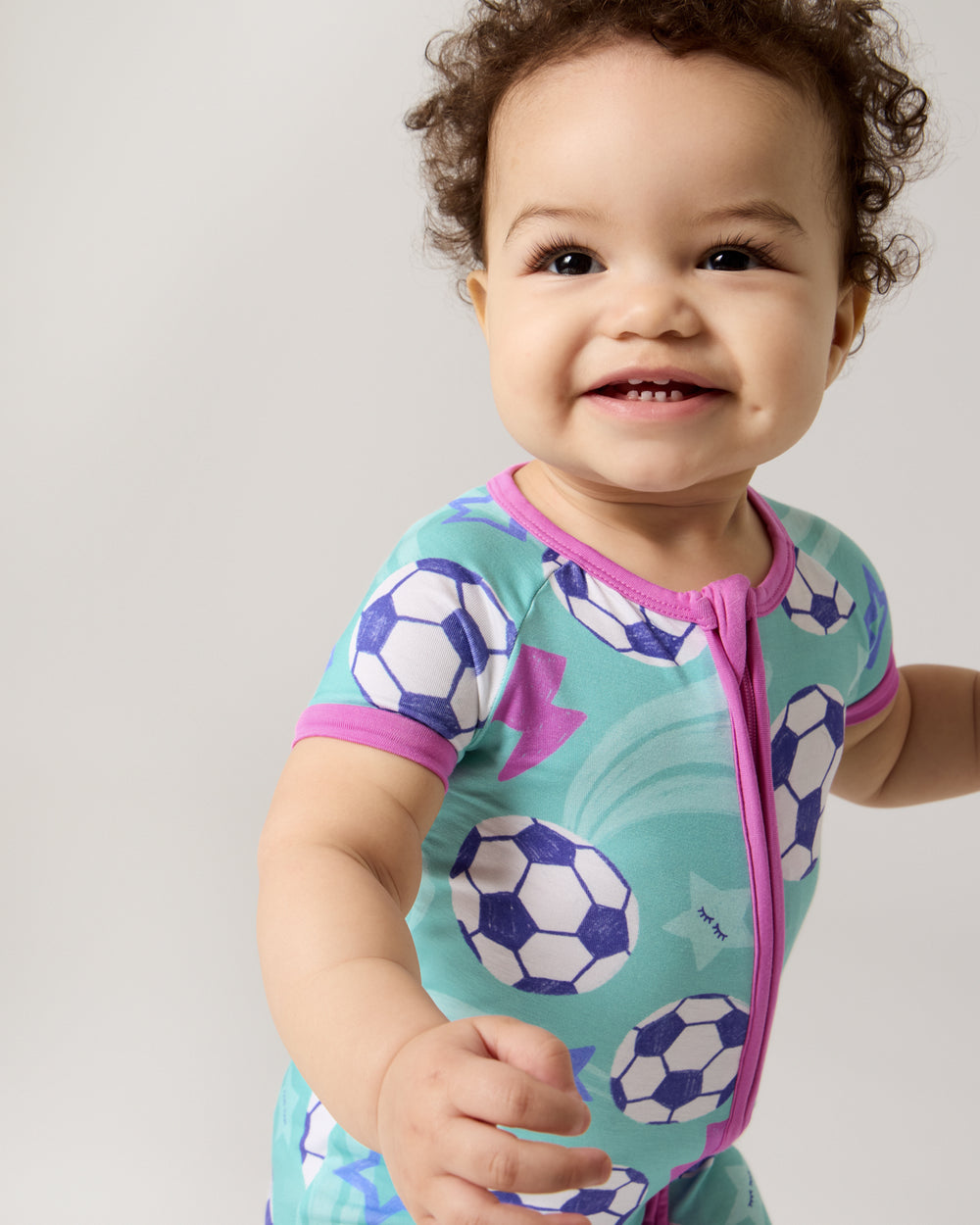 Close up of baby wearing the Aqua Soccer Stars Shorty Zippy