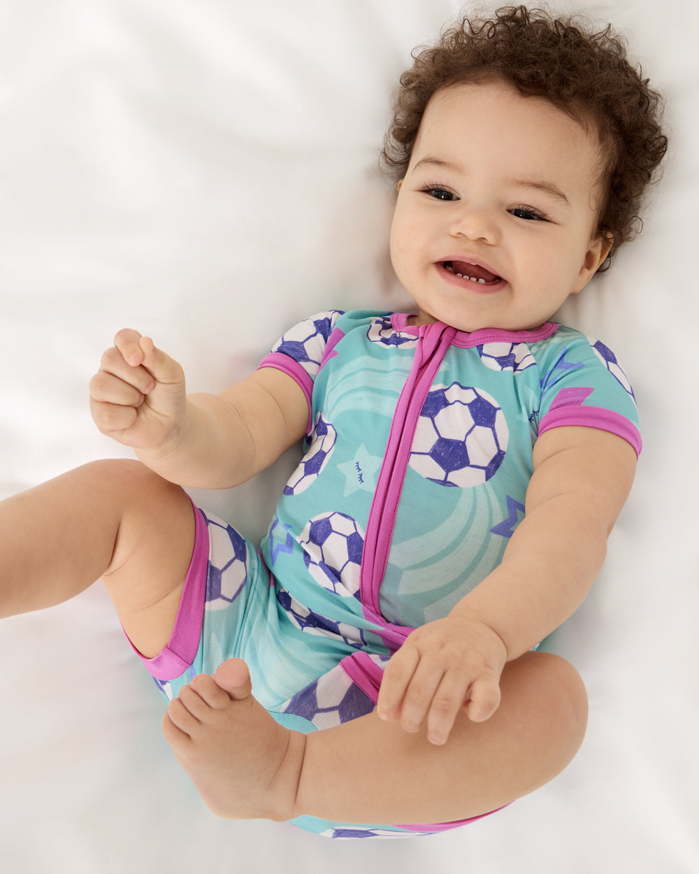 Aerial view of baby wearing the Aqua Soccer Stars Shorty Zippy