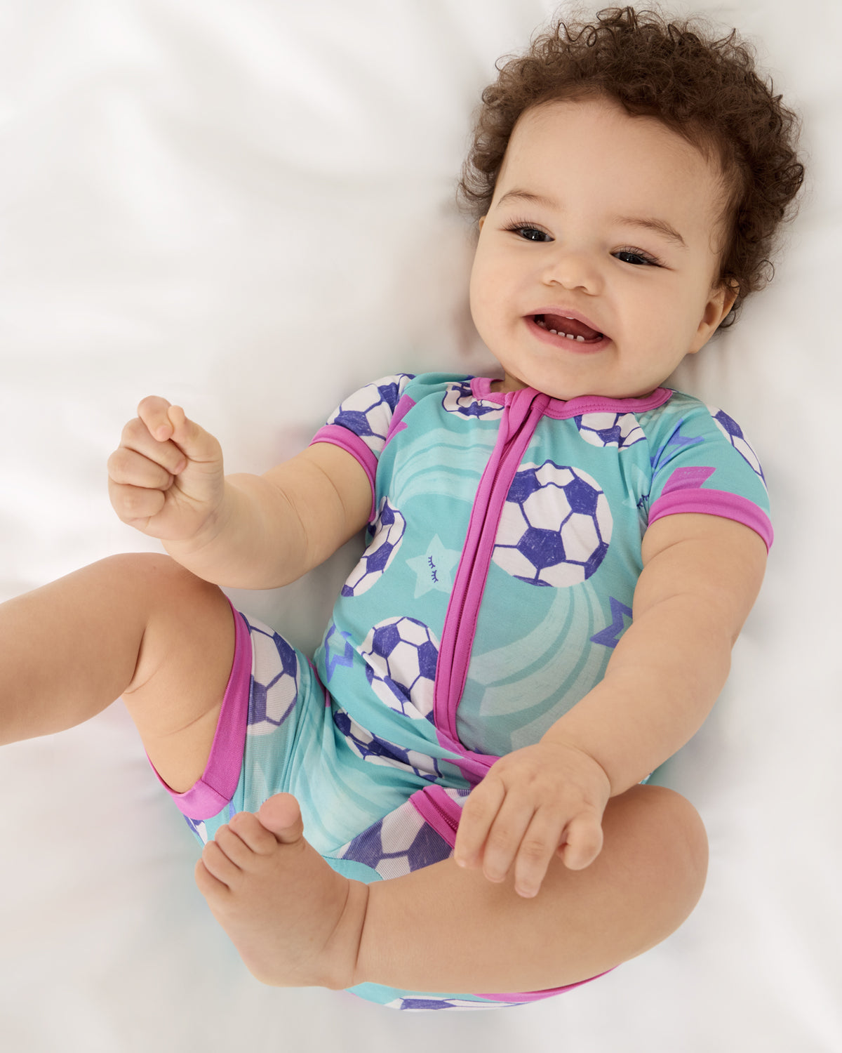 Aerial view of baby wearing the Aqua Soccer Stars Shorty Zippy