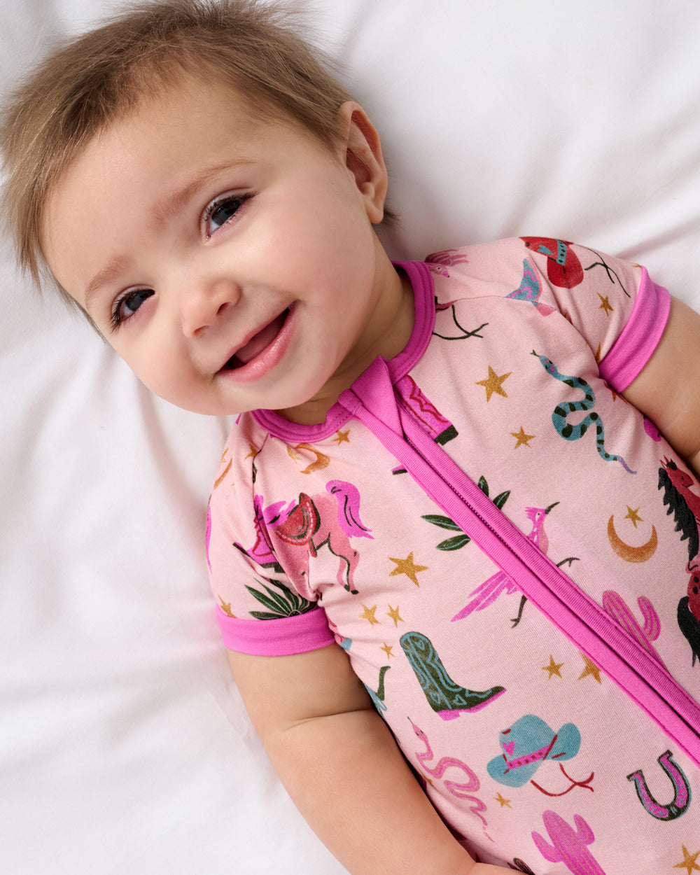 Close up of baby wearing the Pink Rancher Roundup Shorty Zippy