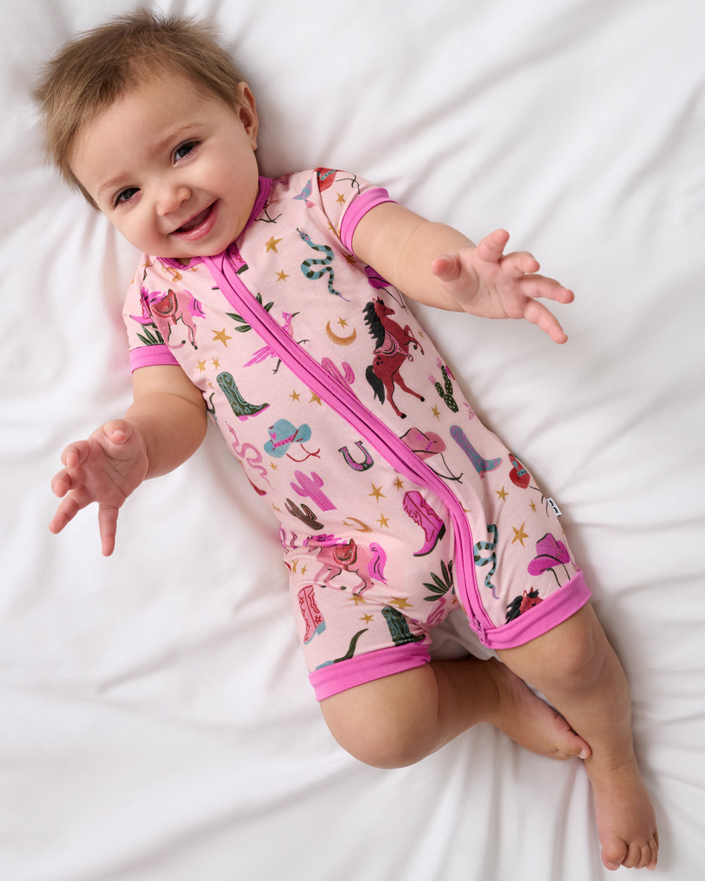 Aerial view of baby wearing the Pink Rancher Roundup Shorty Zippy