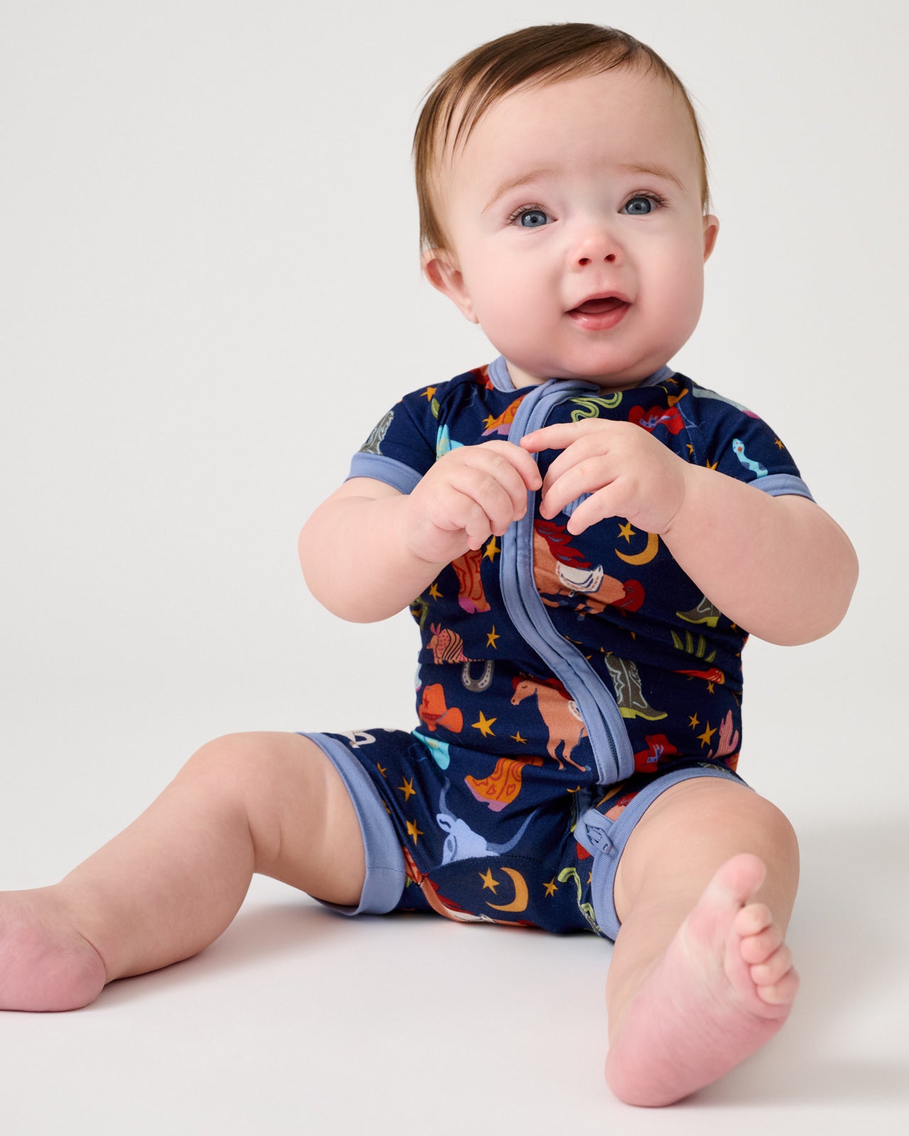 Sitting baby wearing the Blue Rancher Roundup Shorty Zippy