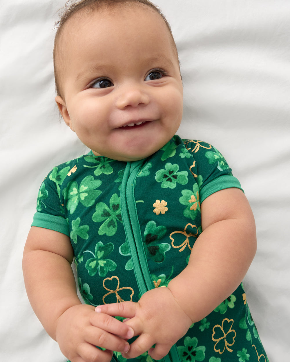Close up of baby wearing the Clover Cuties Shorty Zippy