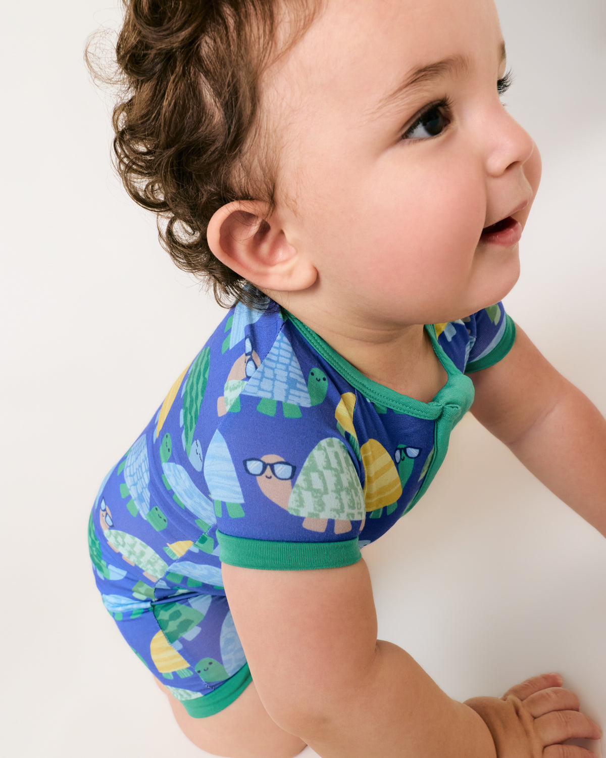 Crawling baby wearing the Shell Parade Shorty Zippy