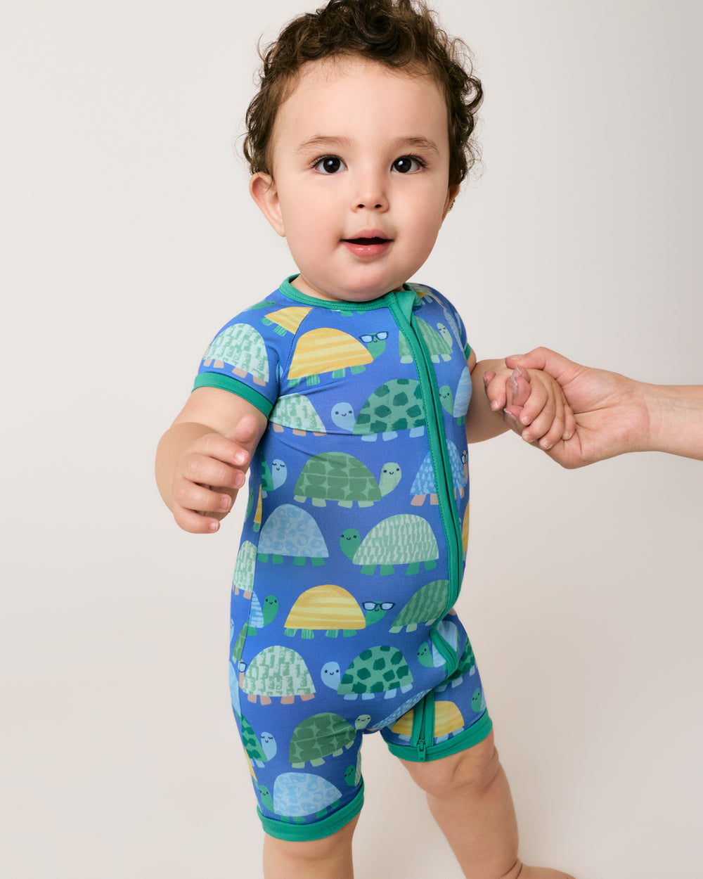 Standing baby wearing the Shell Parade Shorty Zipper Pajama