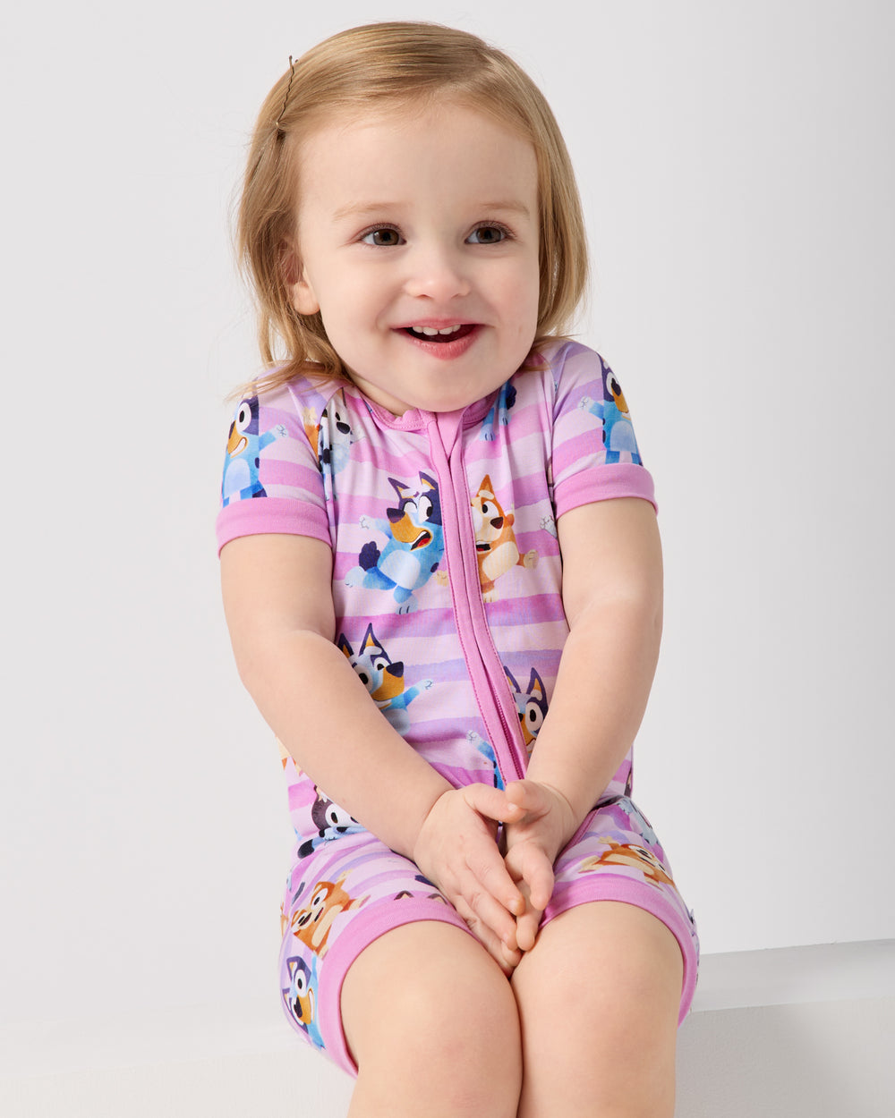 Alternate of sitting girl wearing the Pink Bluey Dance All Day Shorty Zippy