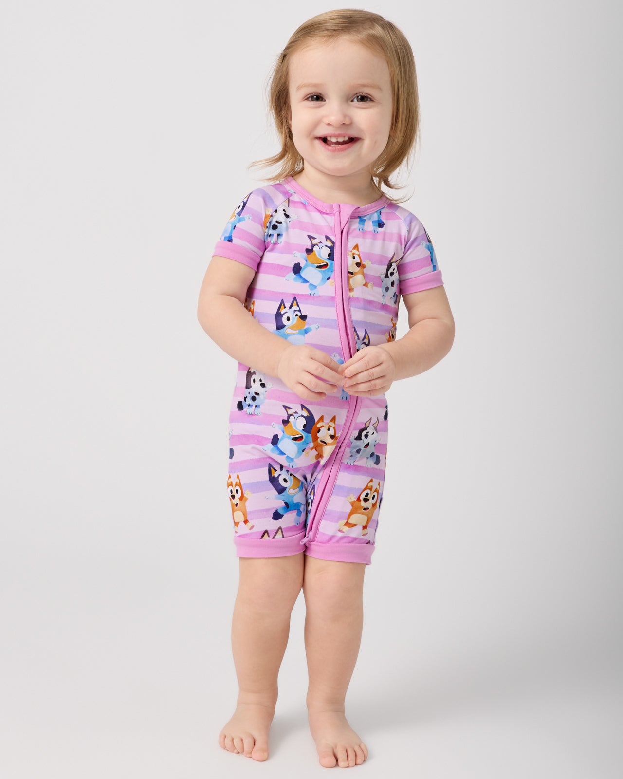 Standing toddler wearing the Pink Bluey Dance All Day Shorty Zippy
