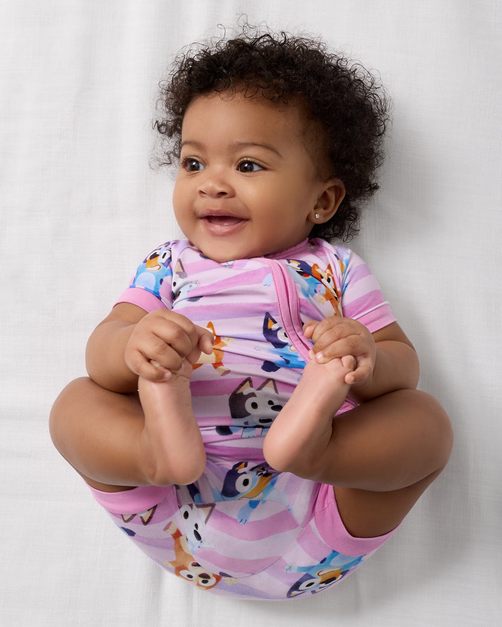 Aerial view of baby wearing the Pink Bluey Dance All Day Shorty Zippy