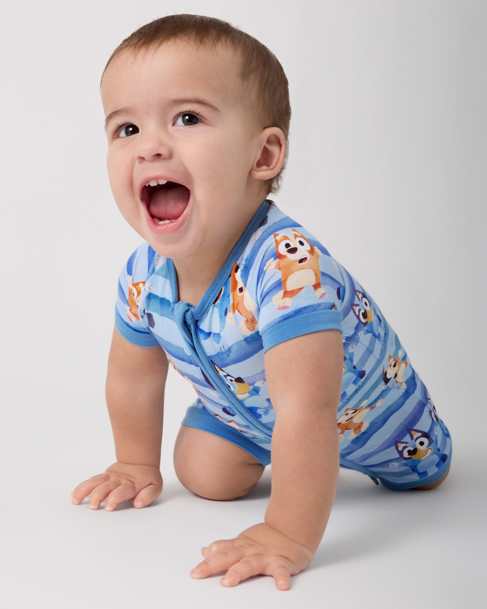 Crawling baby wearing the Bluey Dance All Day Shorty Zippy