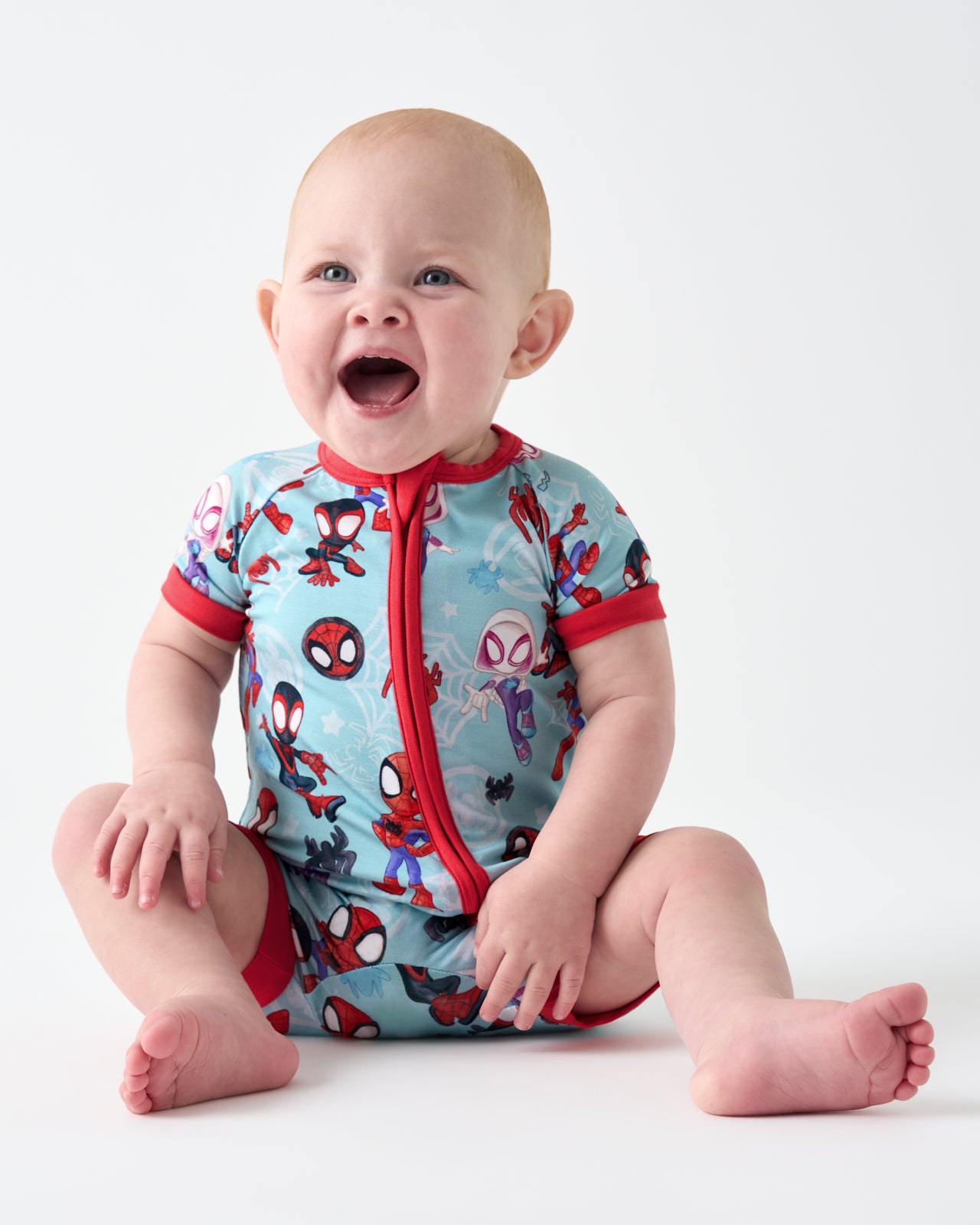 Sitting baby wearing the Spidey & Friends Tiny Webs Shorty Zippy