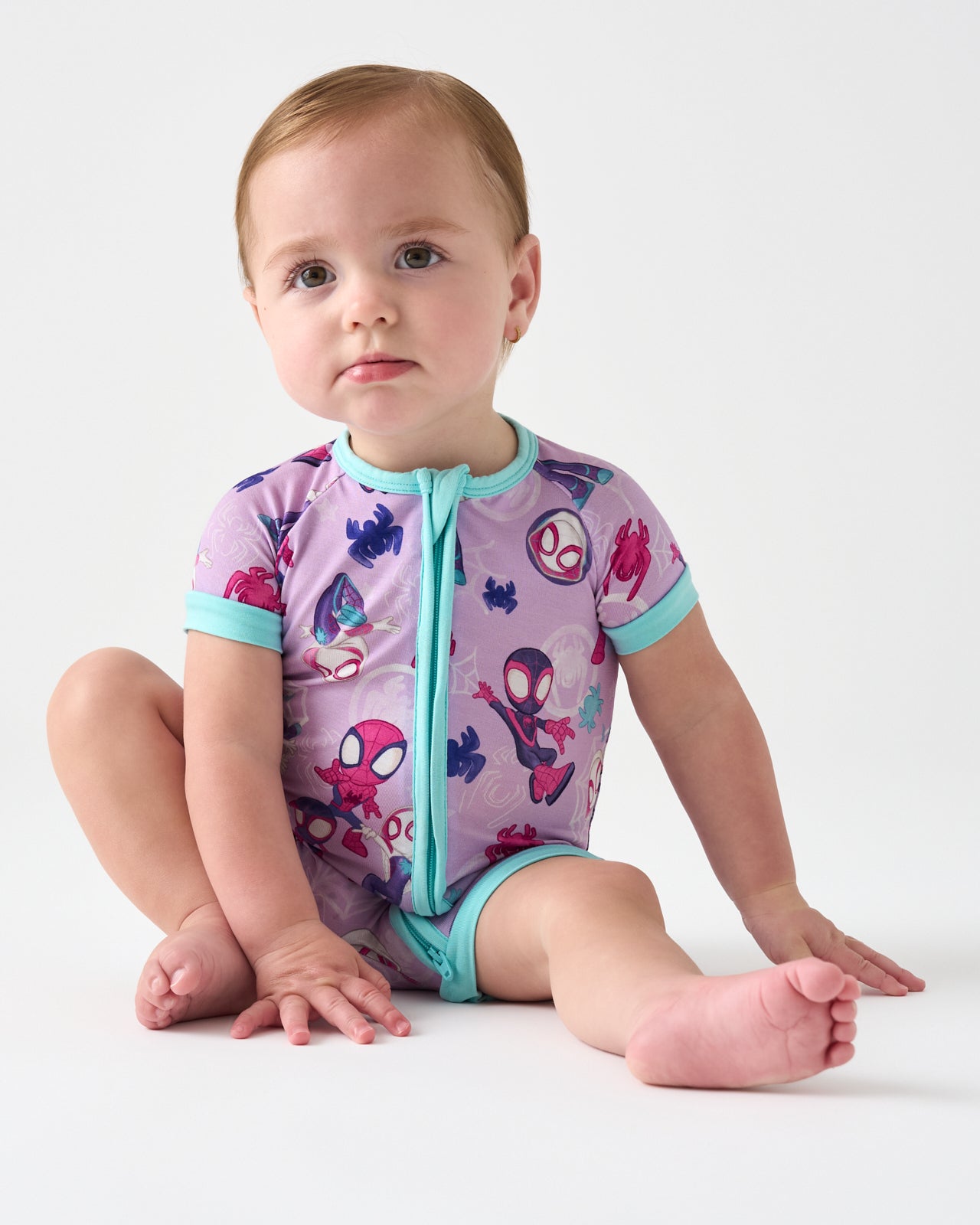 Sitting baby wearing the Spidey & Friends Tiny Webs Shorty Zippy
