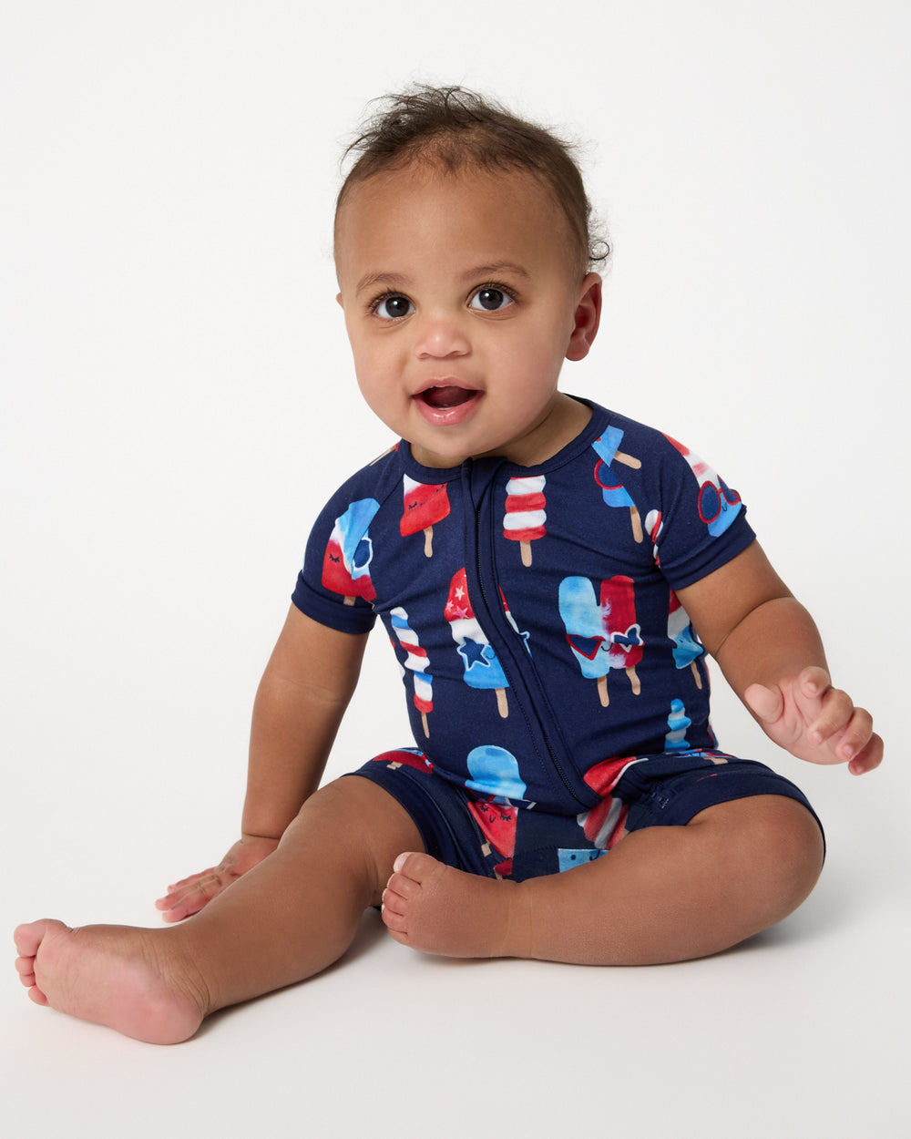 Sitting baby wearing the Sparkle Treats Shorty Zippy