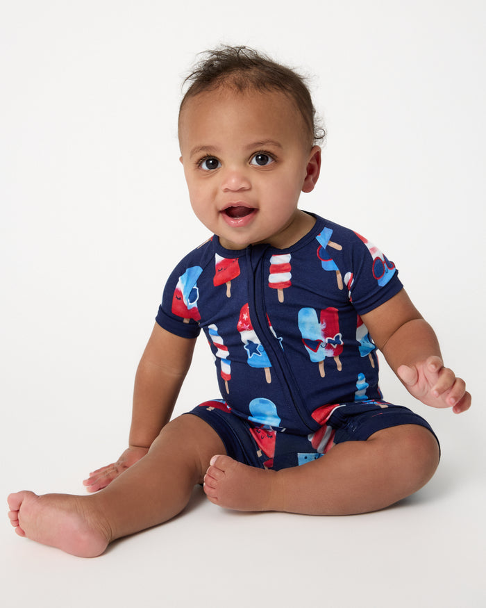 Sitting baby wearing the Sparkle Treats Shorty Zippy