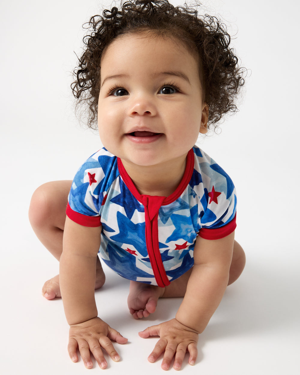 Crawling baby wearing the Starry Splash Shorty Zippy
