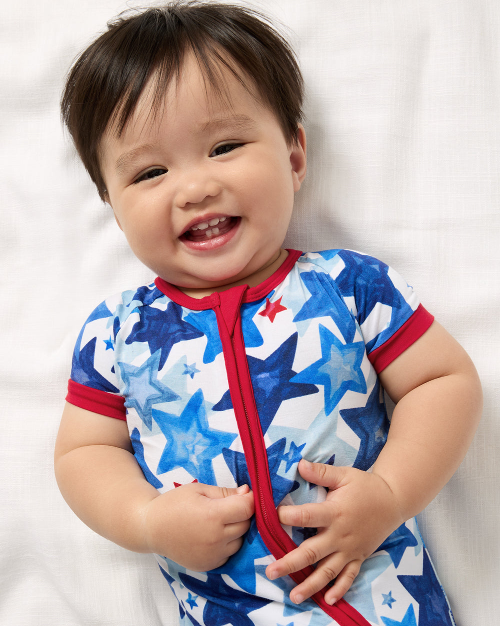 Close up of baby wearing the Starry Splash Shorty Zippy