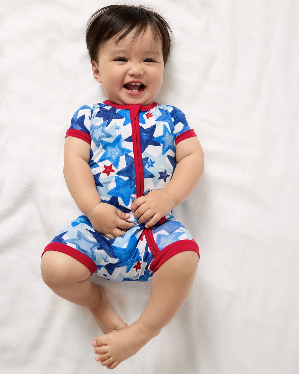 Aerial view of baby wearing the Starry Splash Shorty Zippy