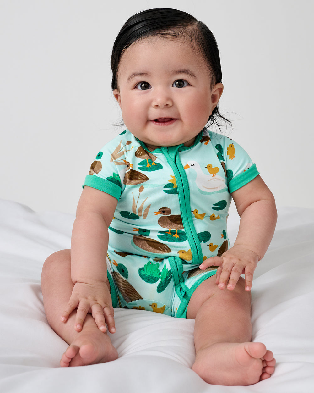 Sitting newborn wearing the Puddle Jumpers Shorty Zippy